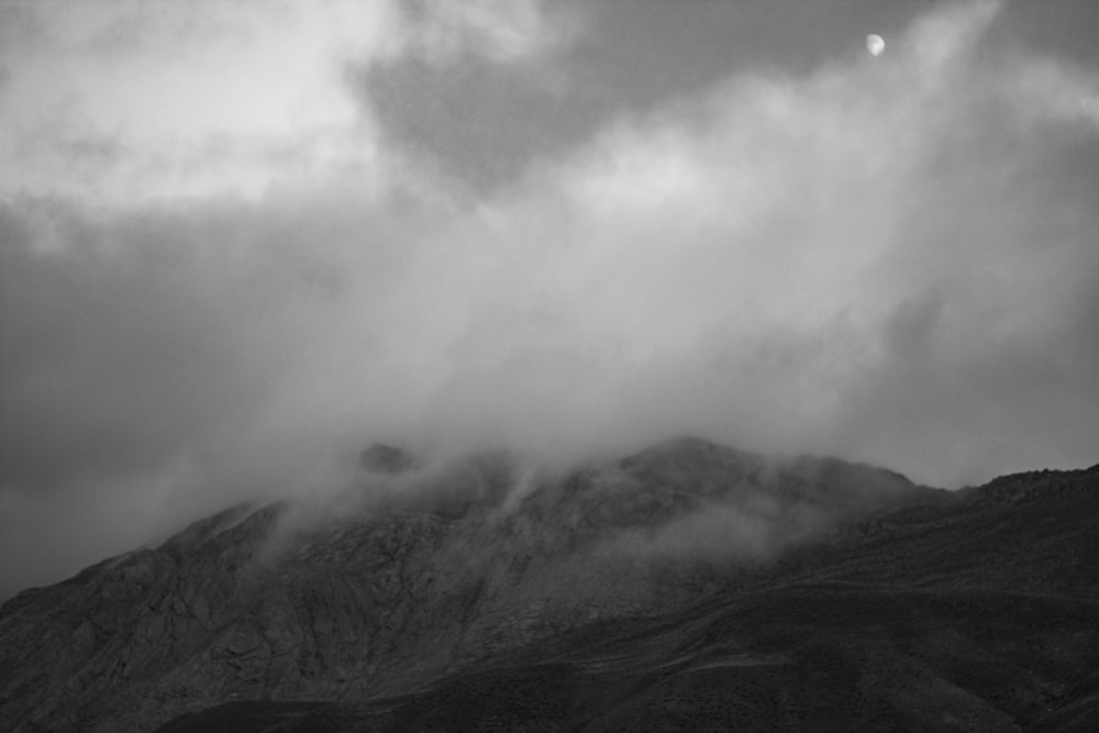 grayscale photo of mountain with fog