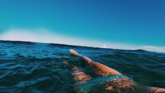 A triathlete swimming in open water during a competition.