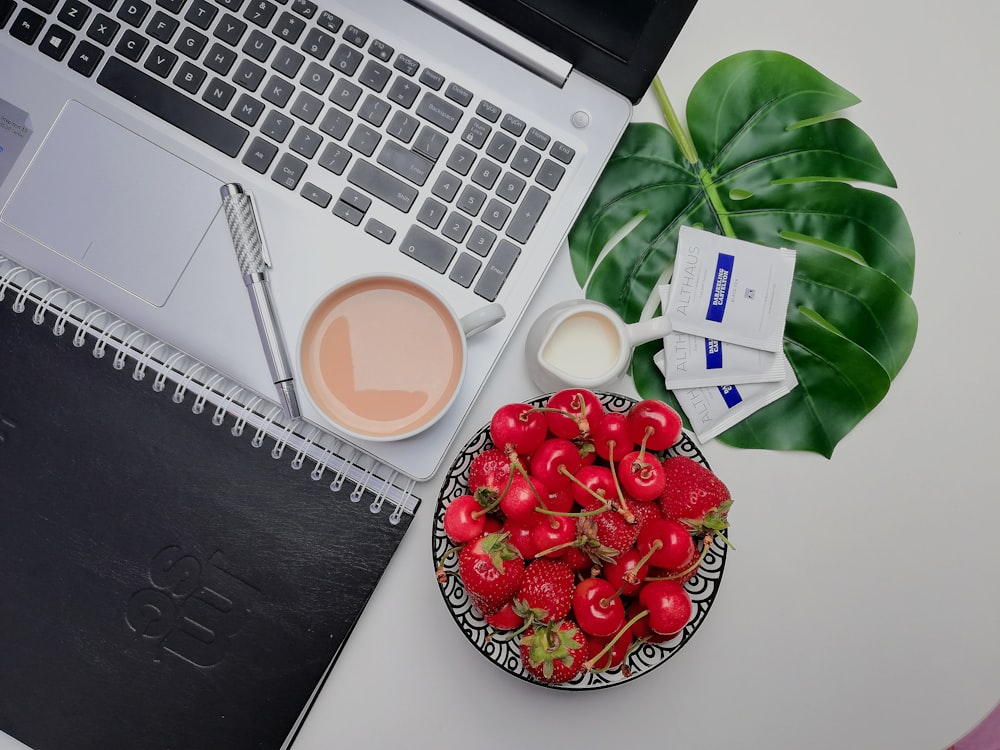 white ceramic mug on gray laptop computer