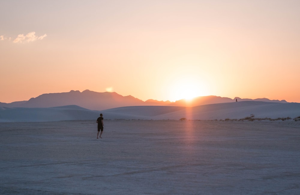 landscape photo of a man at a field in winter