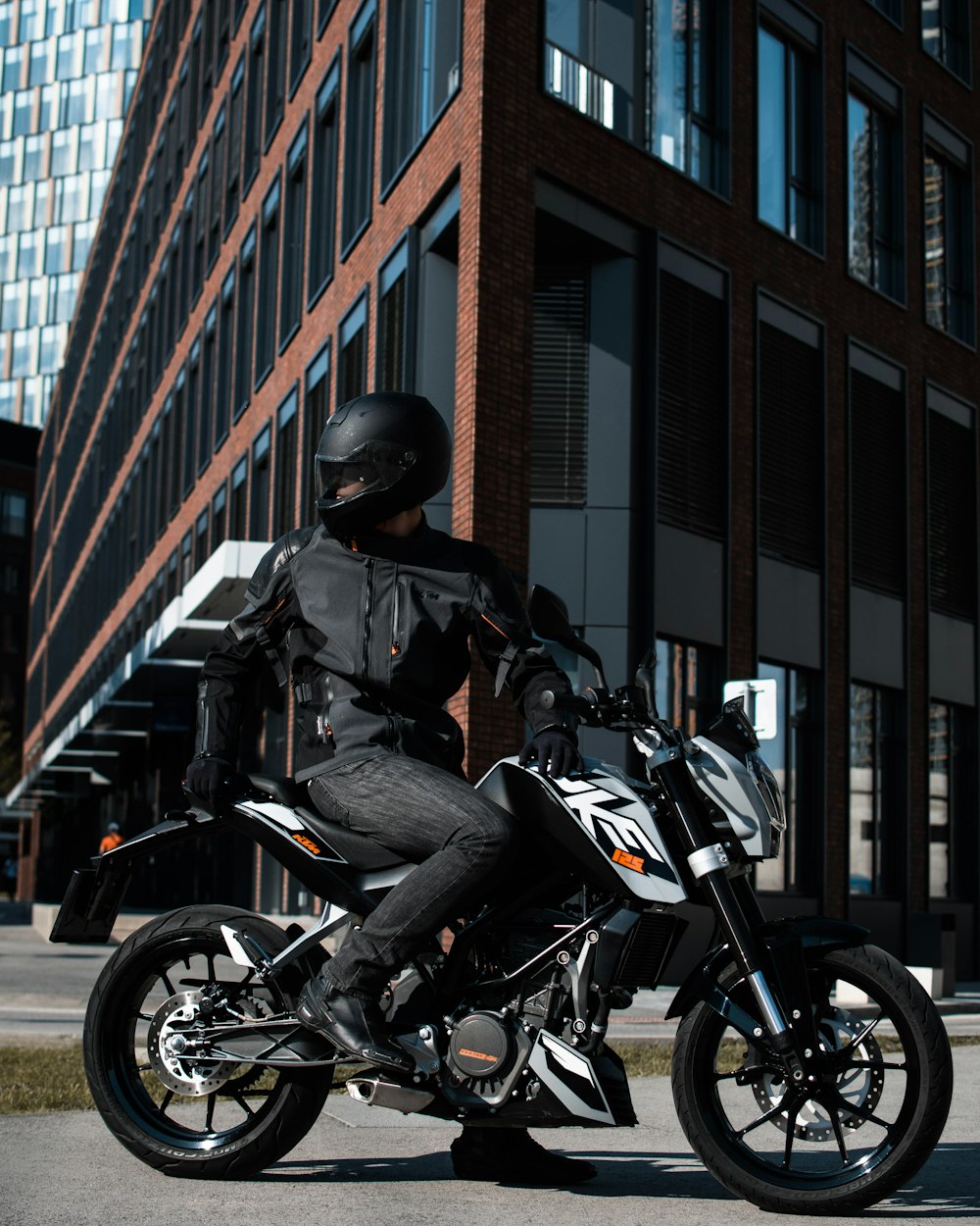 person riding black and white naked motorcycle