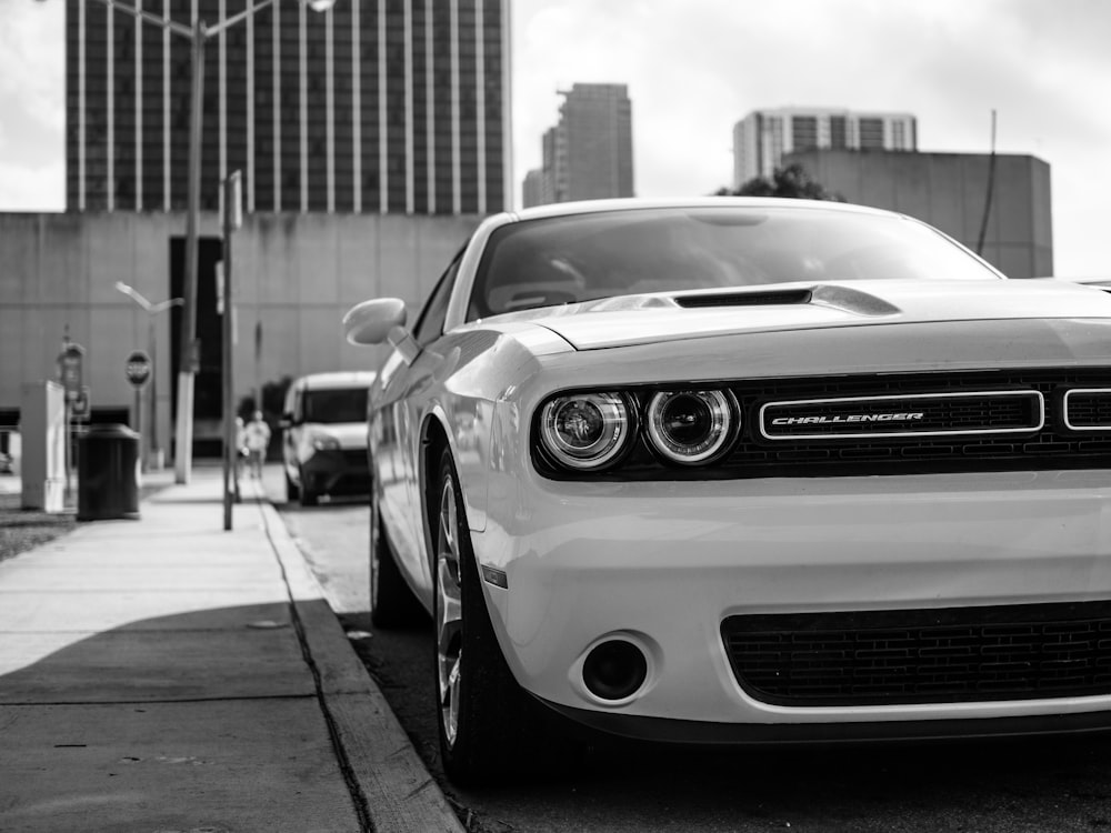white Dodge Challenger parked beside curb