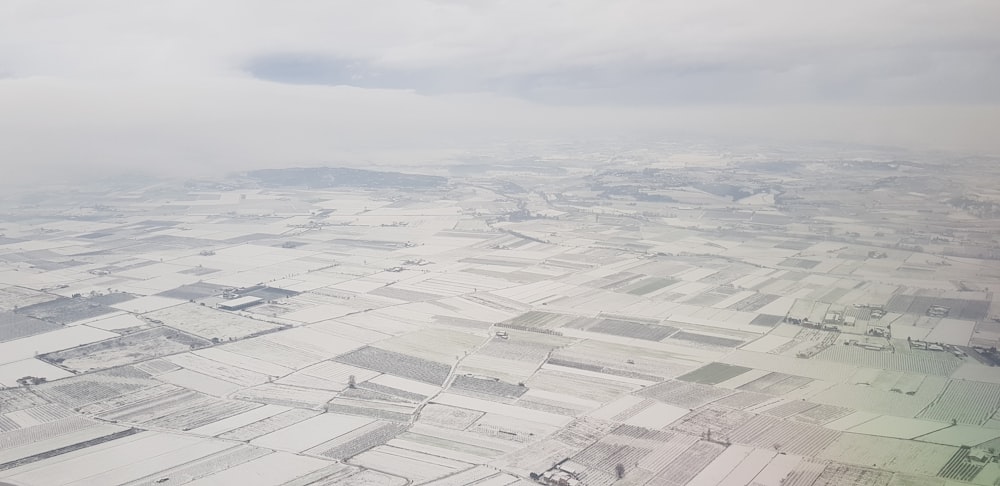 a view from an airplane of a snowy landscape