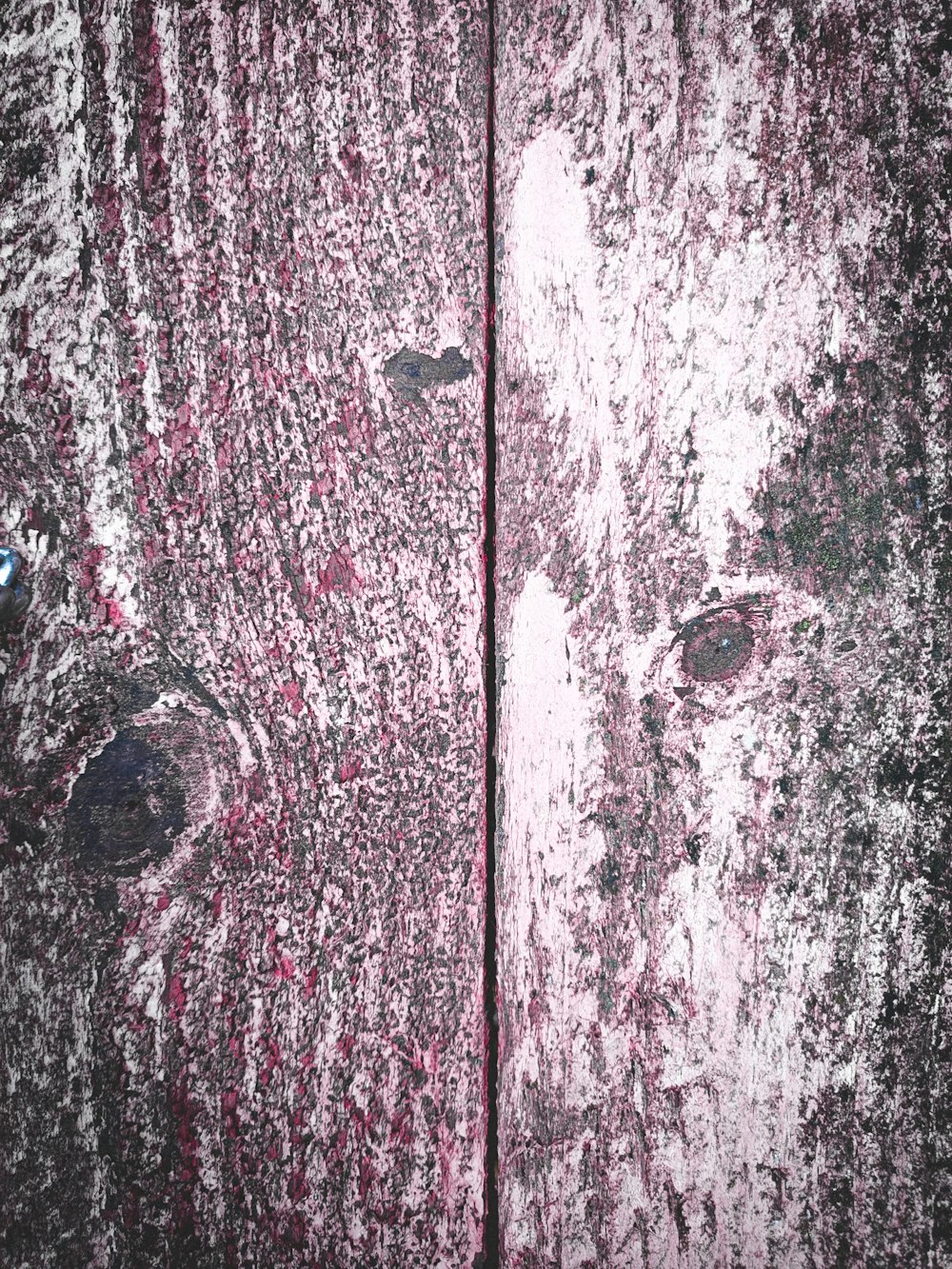 a close up of a wooden surface with peeling paint