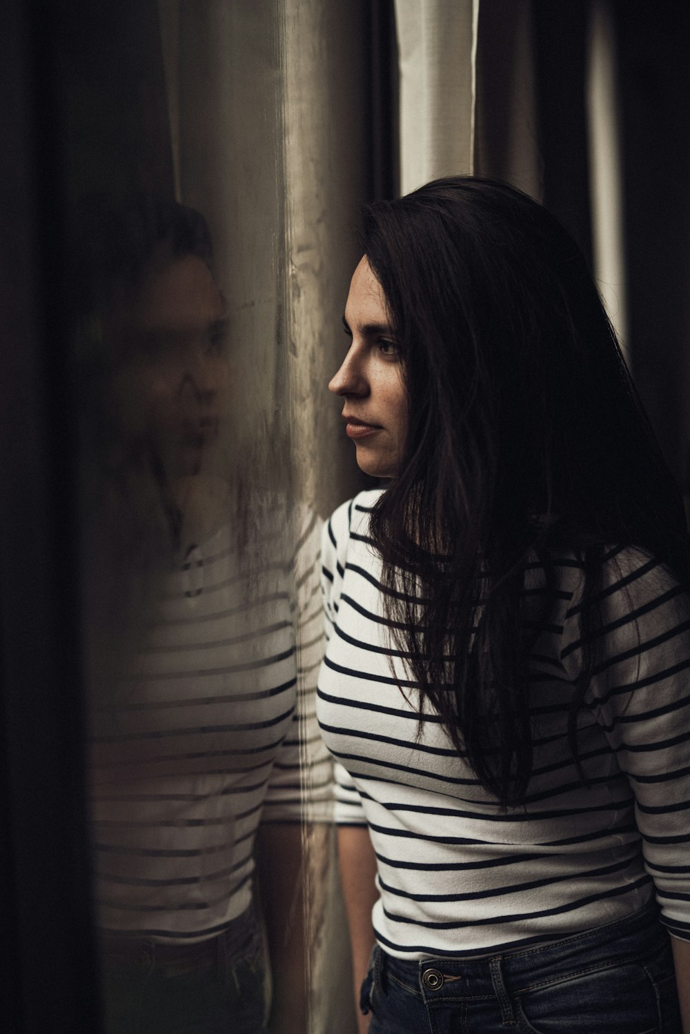 woman wears white and black striped long-sleeved shirt