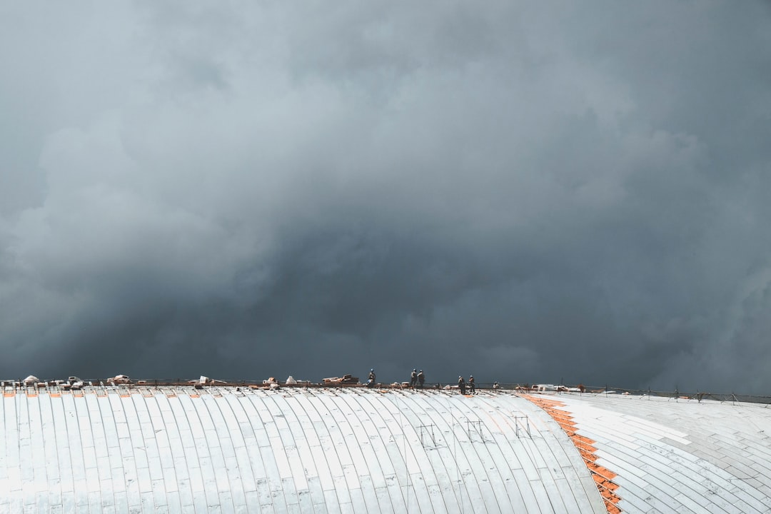 people standing on gray roof