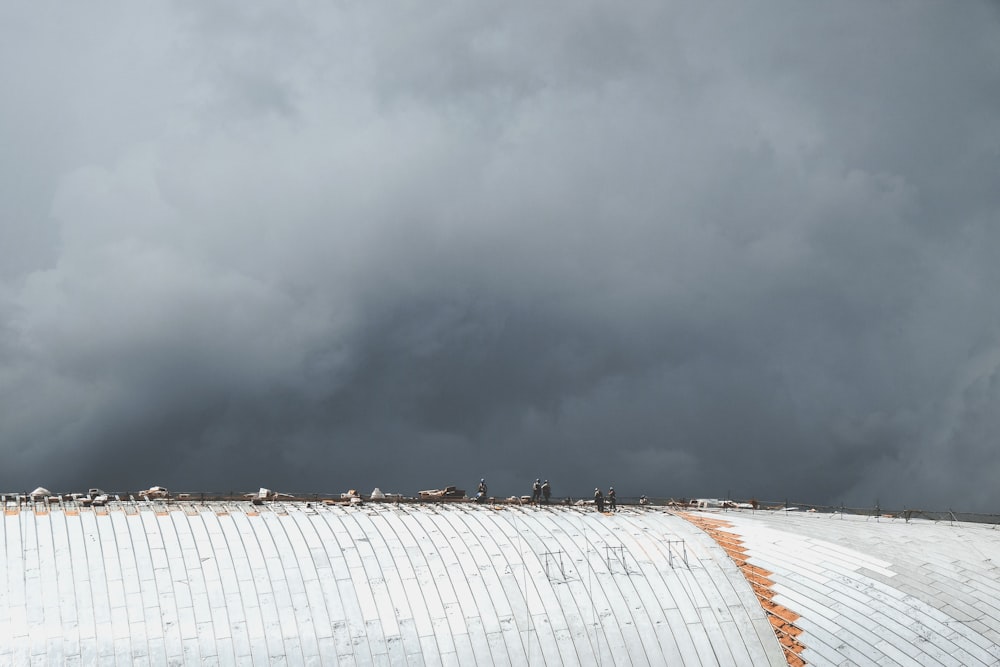 people standing on gray roof