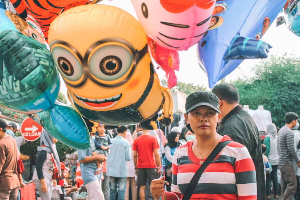 a woman standing in front of a bunch of balloons