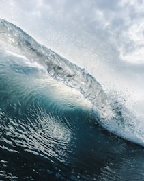 a large wave in the middle of the ocean