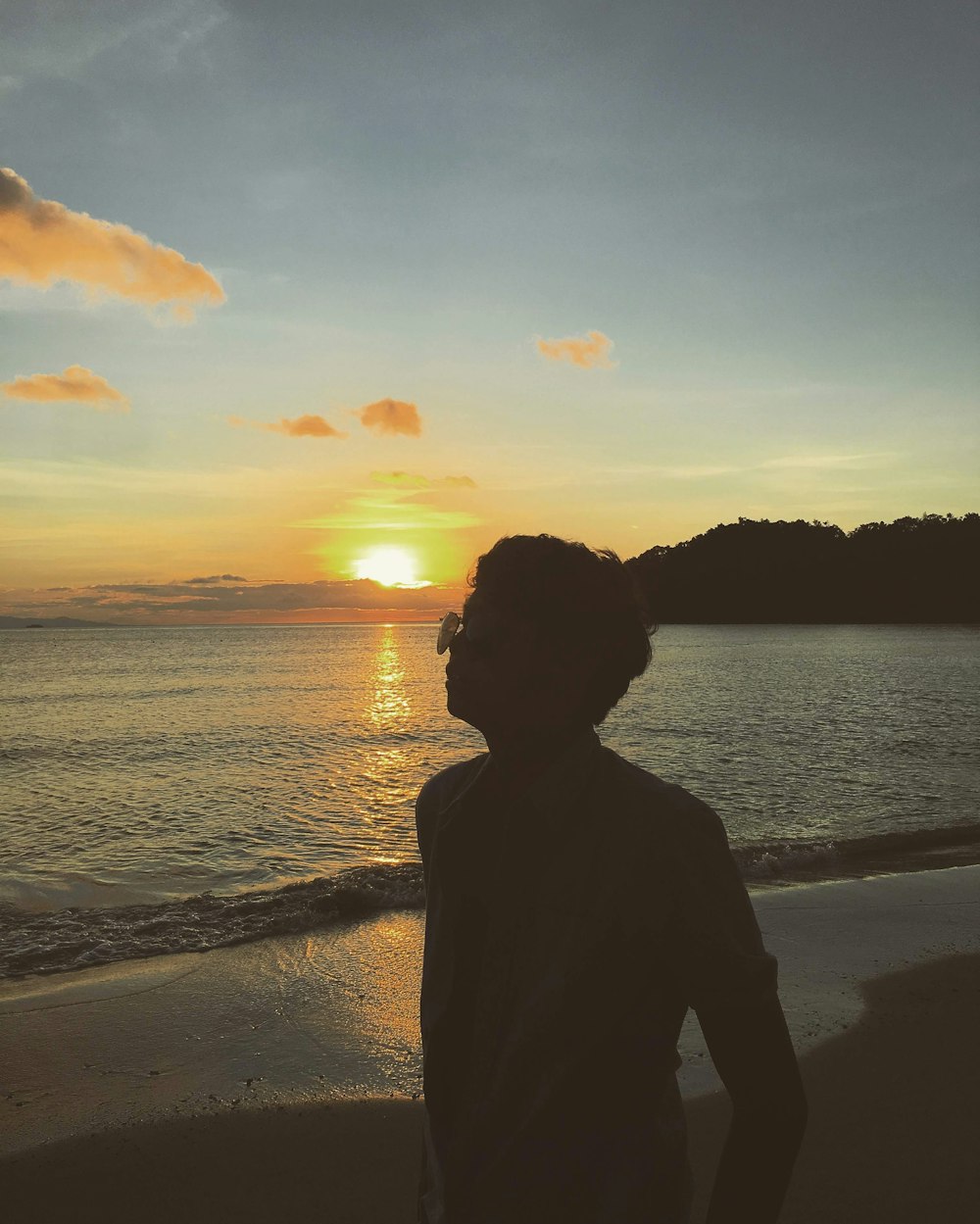 silhouette photo of man beside seashore