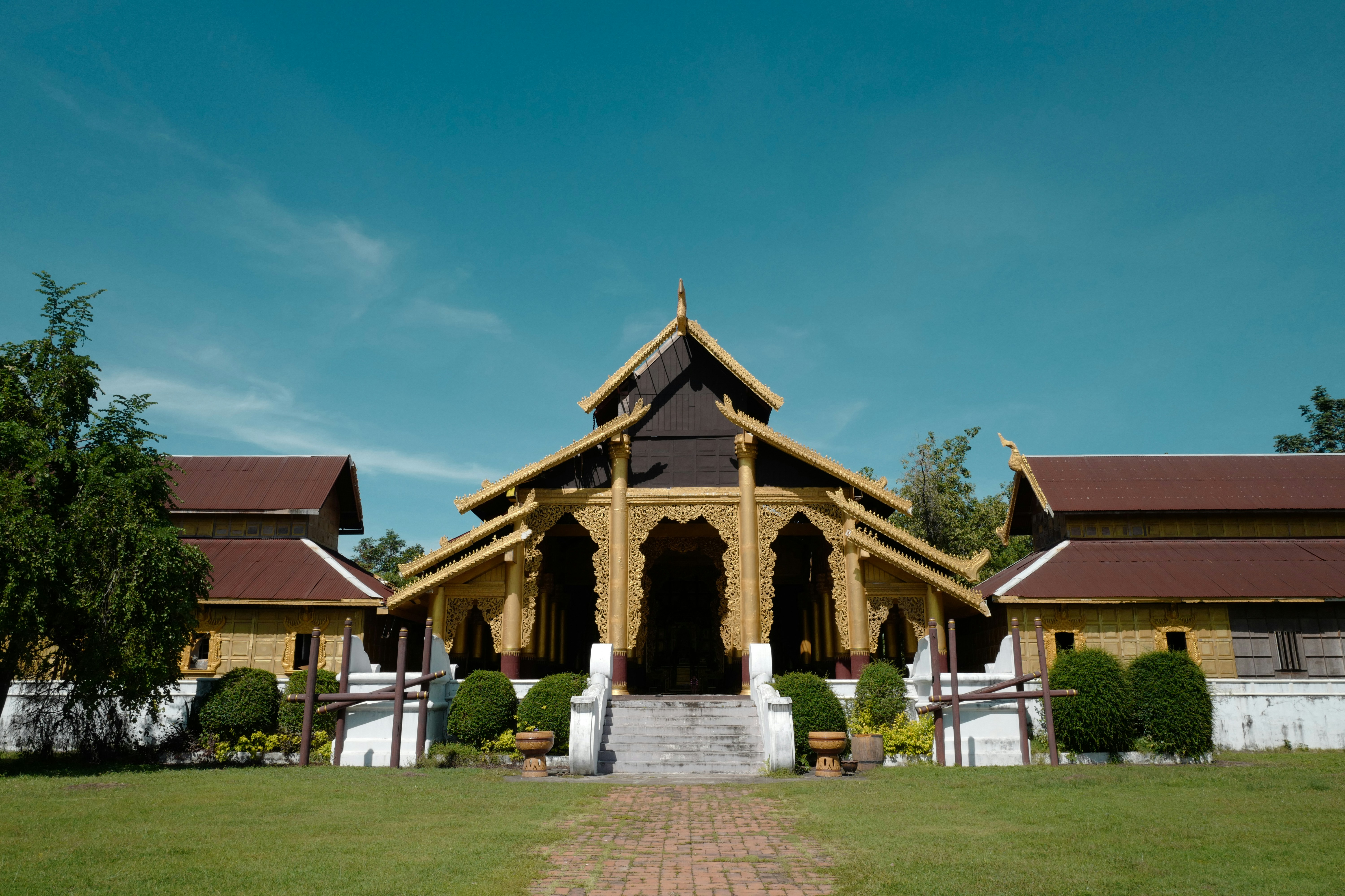 brown building with white stairs during day