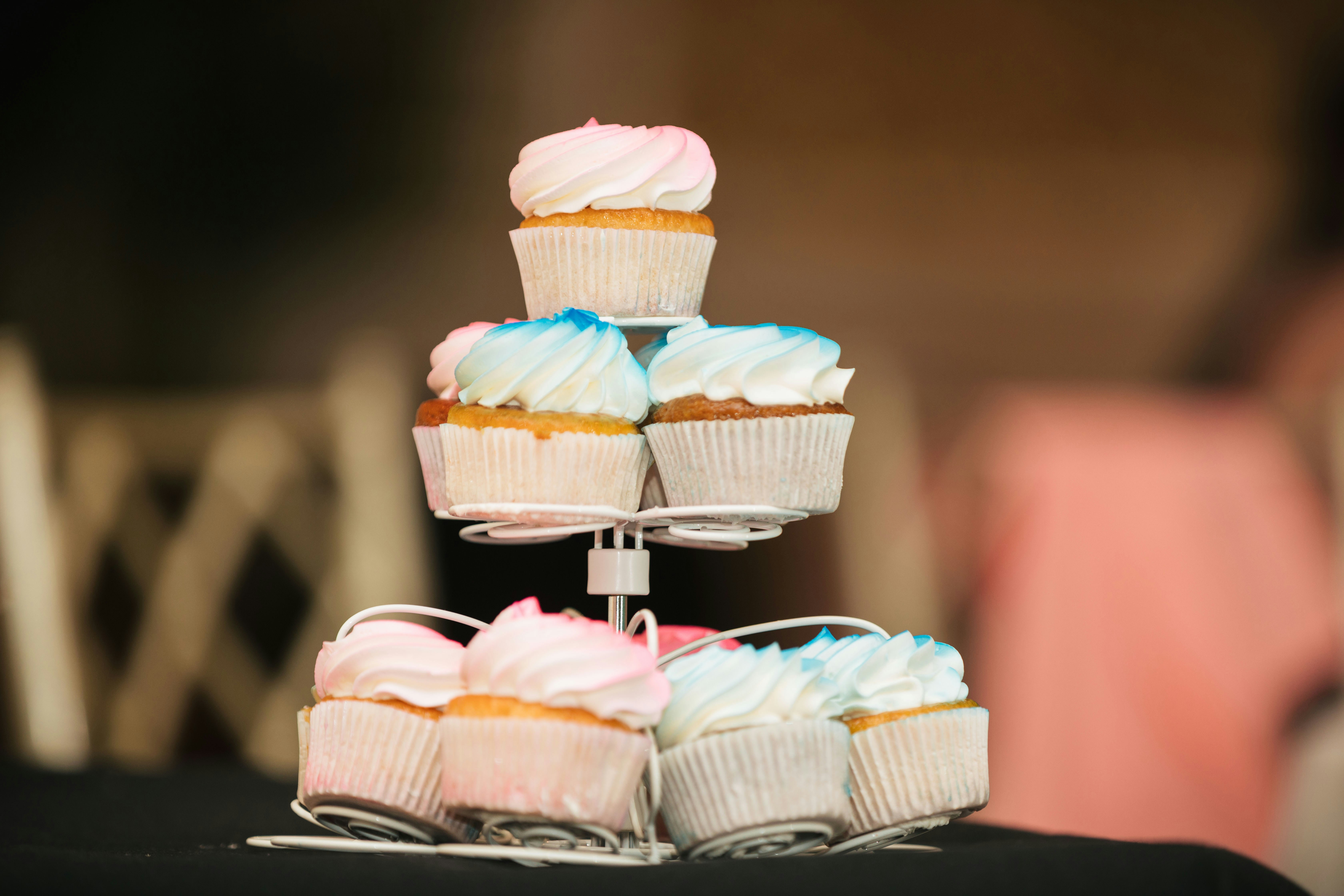 selective focus photography of cupcakes on white rack