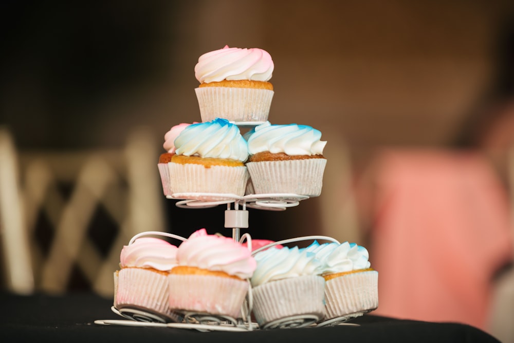 selective focus photography of cupcakes on white rack