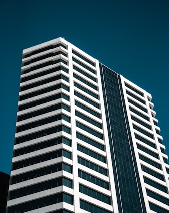 low angle photo of white curtain wall building