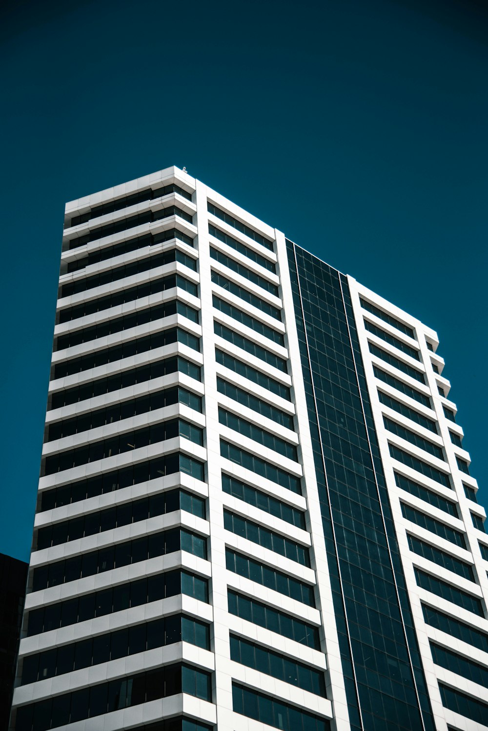 low angle photo of white curtain wall building