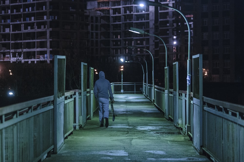 man walking on bridge