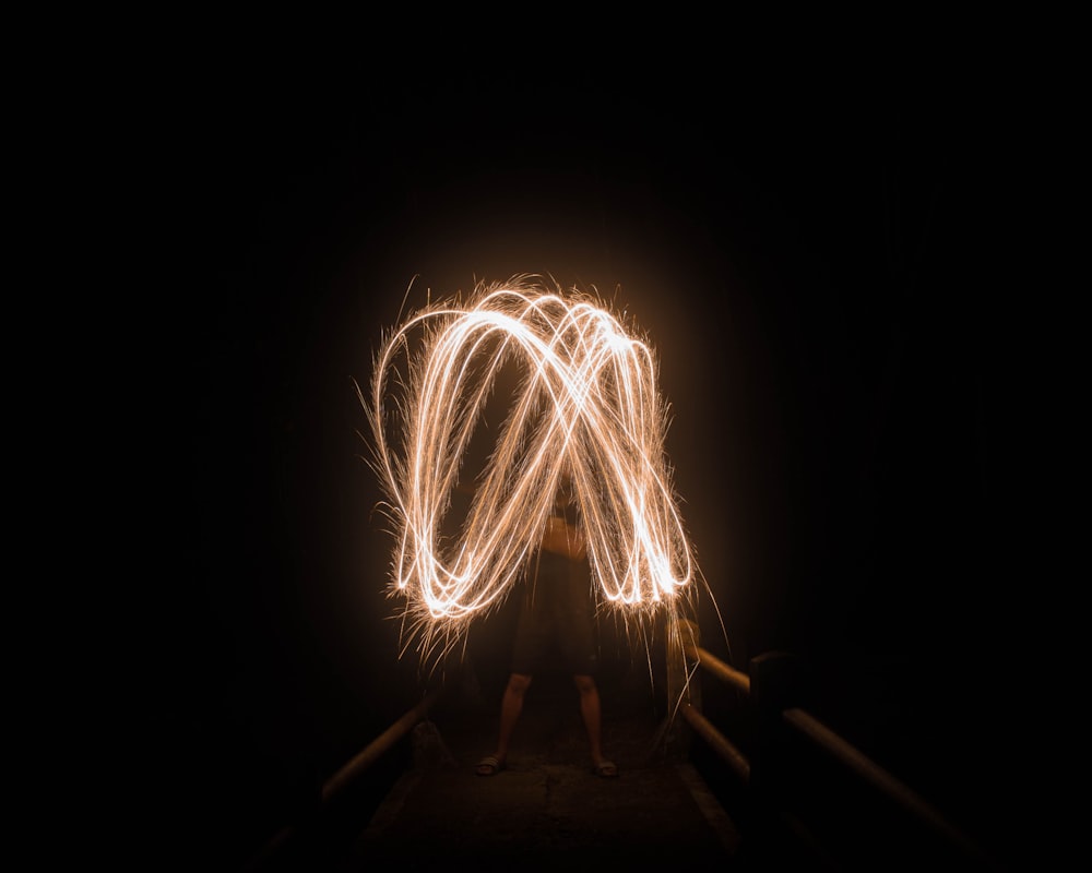 man holding light in dark night