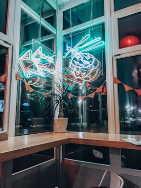 A cozy corner of Coral Bean cafe with vibrant aquariums glowing softly in the background.