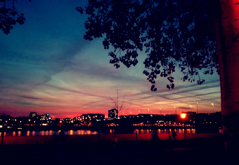 crimson sky over city by the bay at dusk