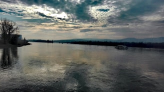 body of water under cloudy sky