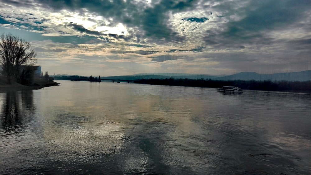 body of water under cloudy sky