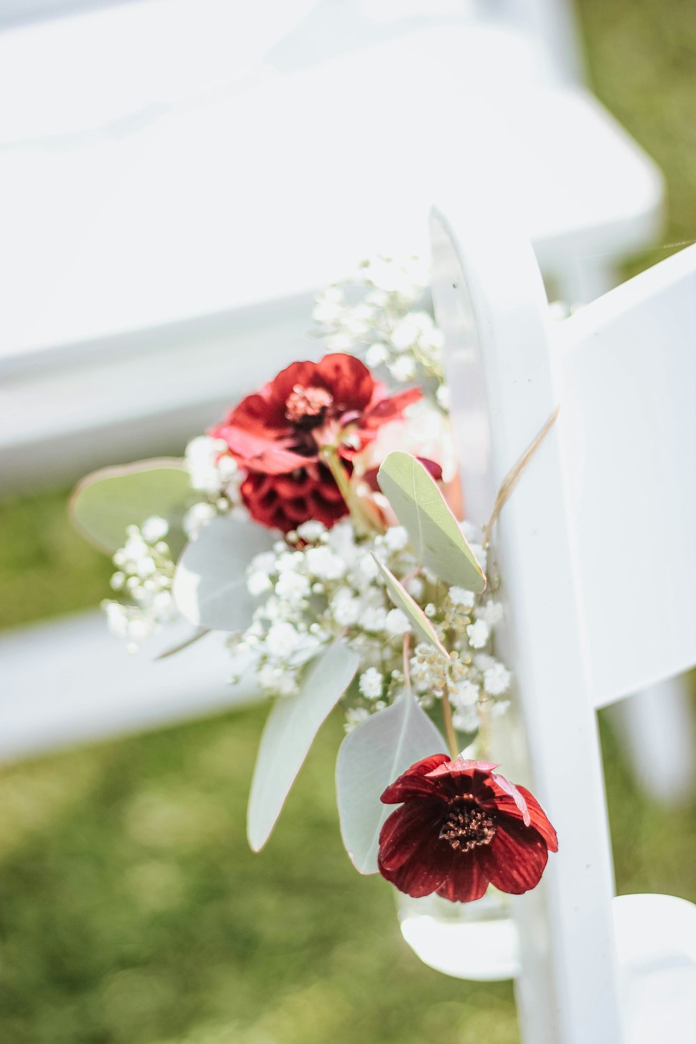 a white chair with a bouquet of flowers on it