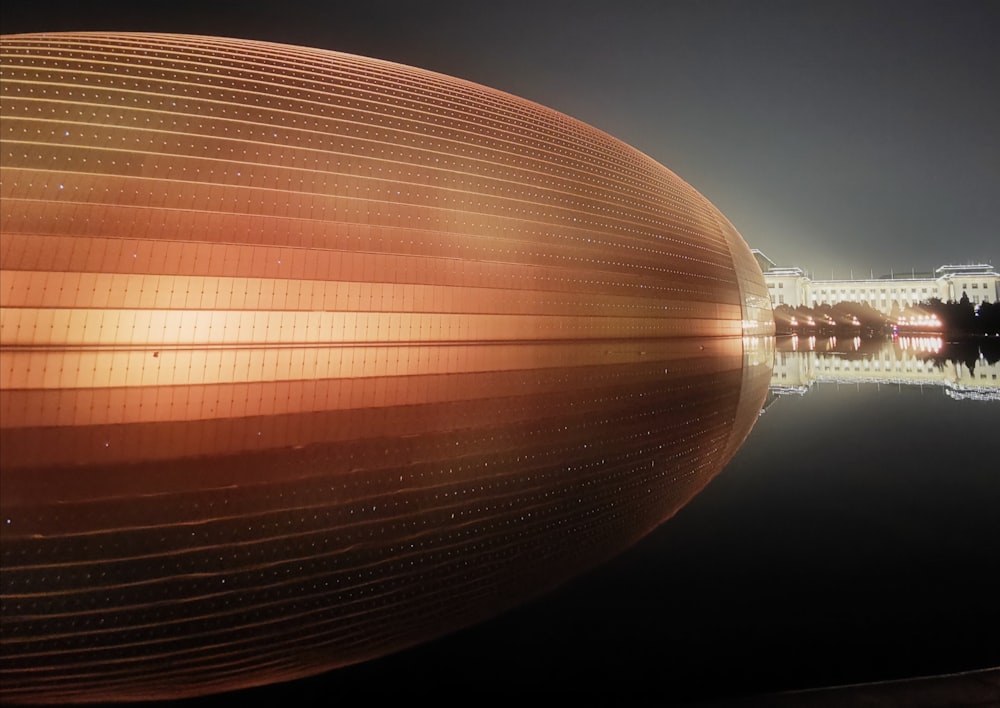 a large building with a reflection in the water