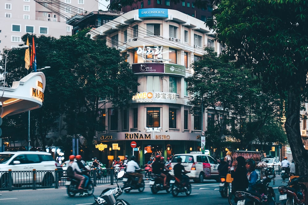 people riding motorcycle crossing street