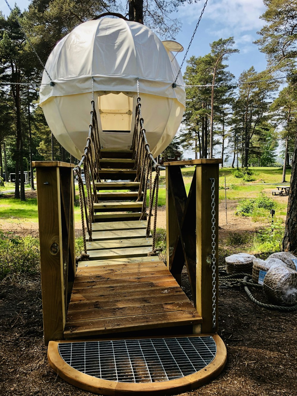 white hanging tent with brown wooden stairs