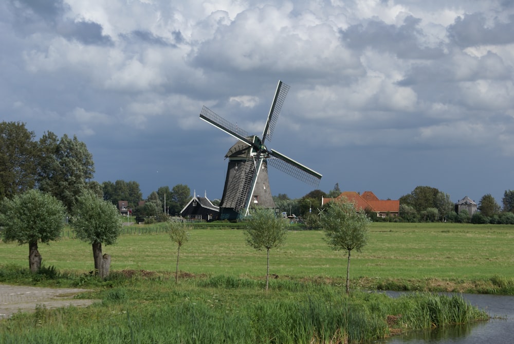 grey and white windmill across green grass field