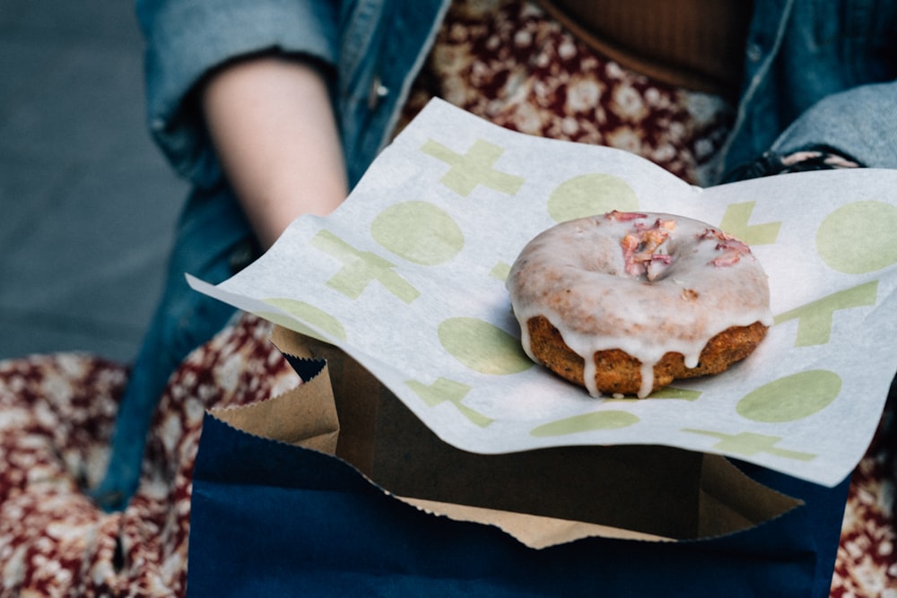 donut holding by person wearing blue dress shir