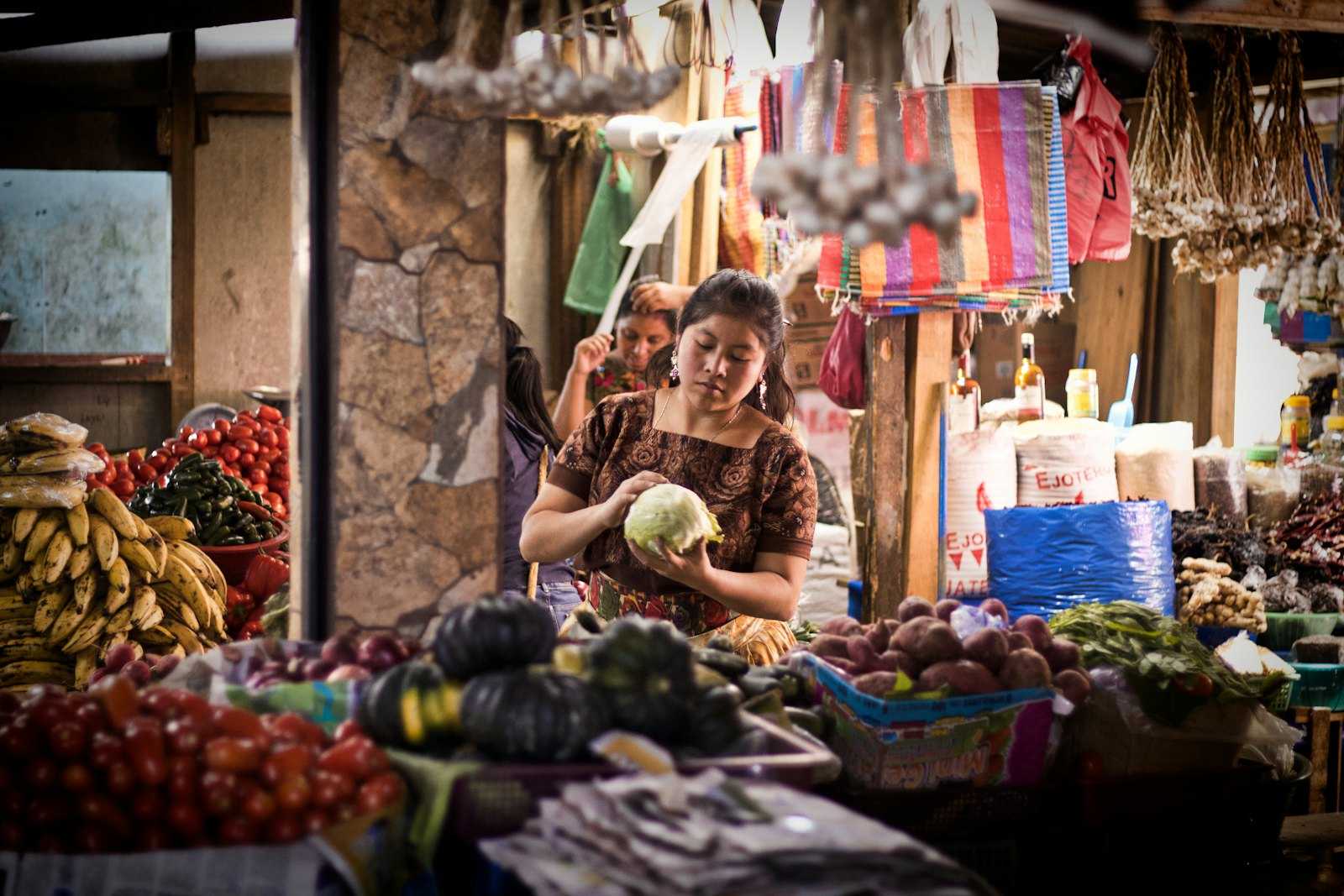 Una vendedora atiende su puesto en un mercado de Guatemala