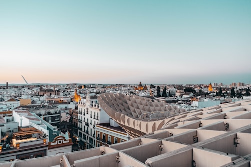 A panoramic view of CyberHub’s modern architecture under a pink-hued sunset.