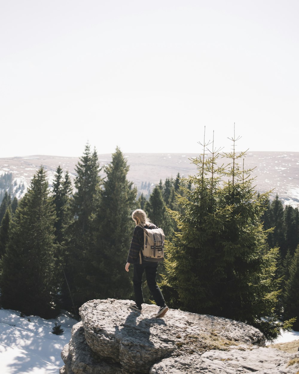 unknown person standing near green-leafed tree