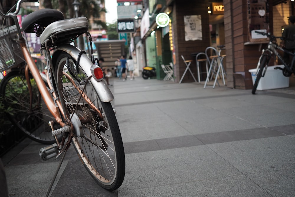 grey city bike parked on sidewalk