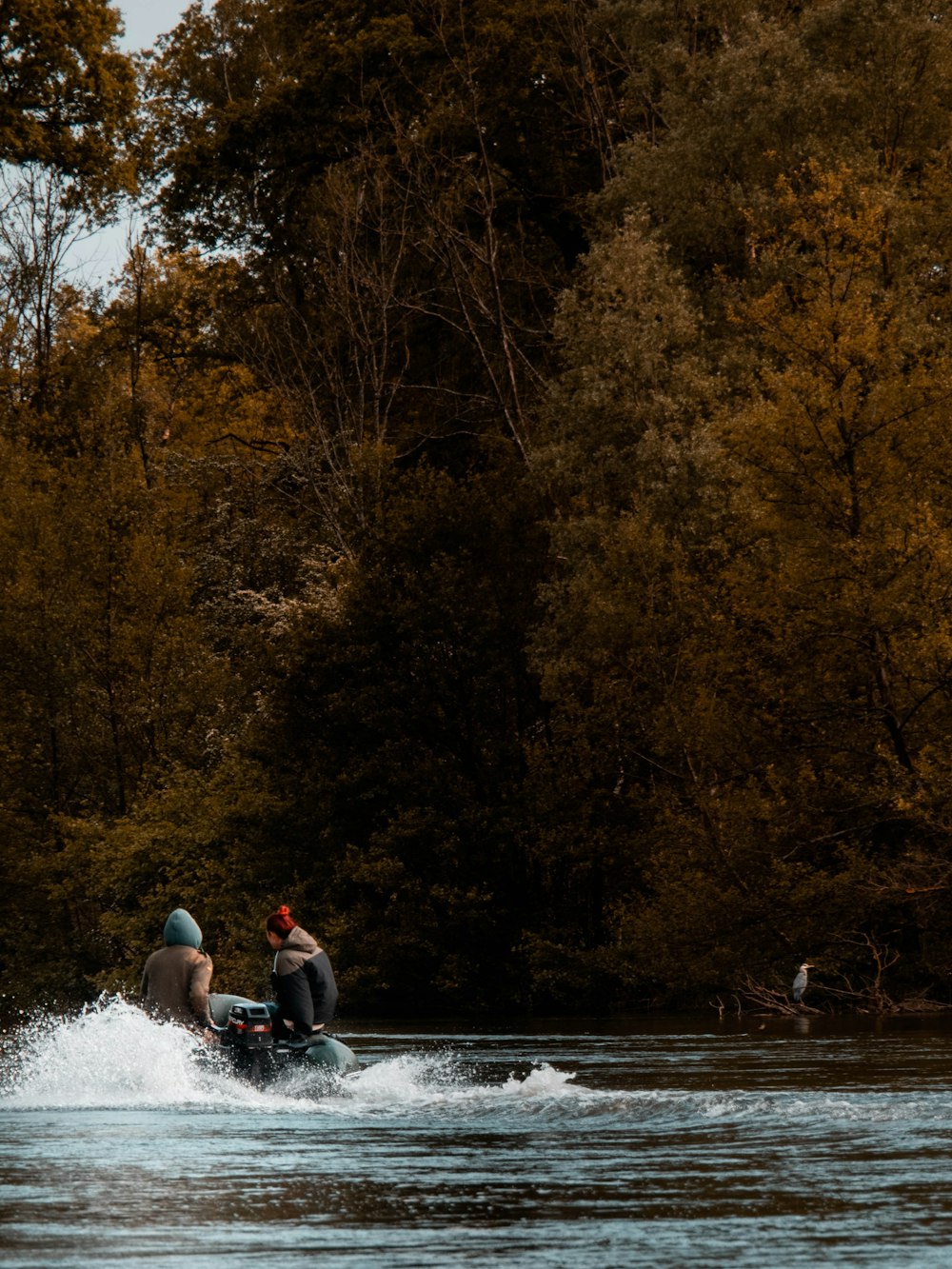 two man riding gray boat