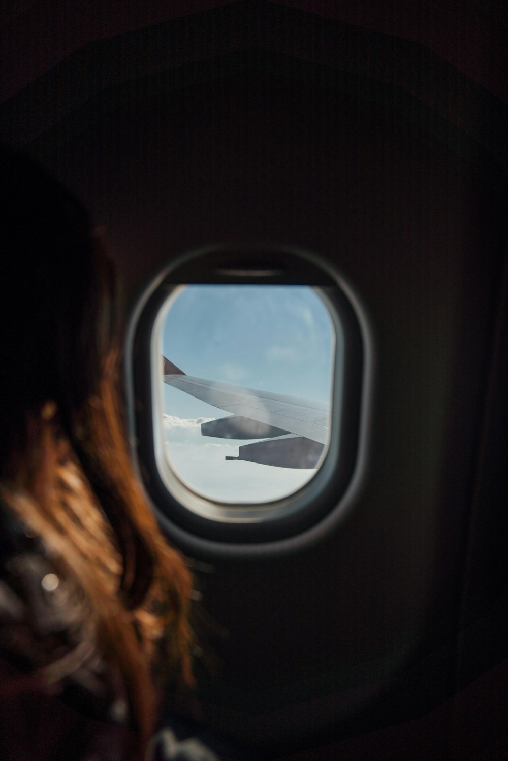 woman sitting beside airplane window
