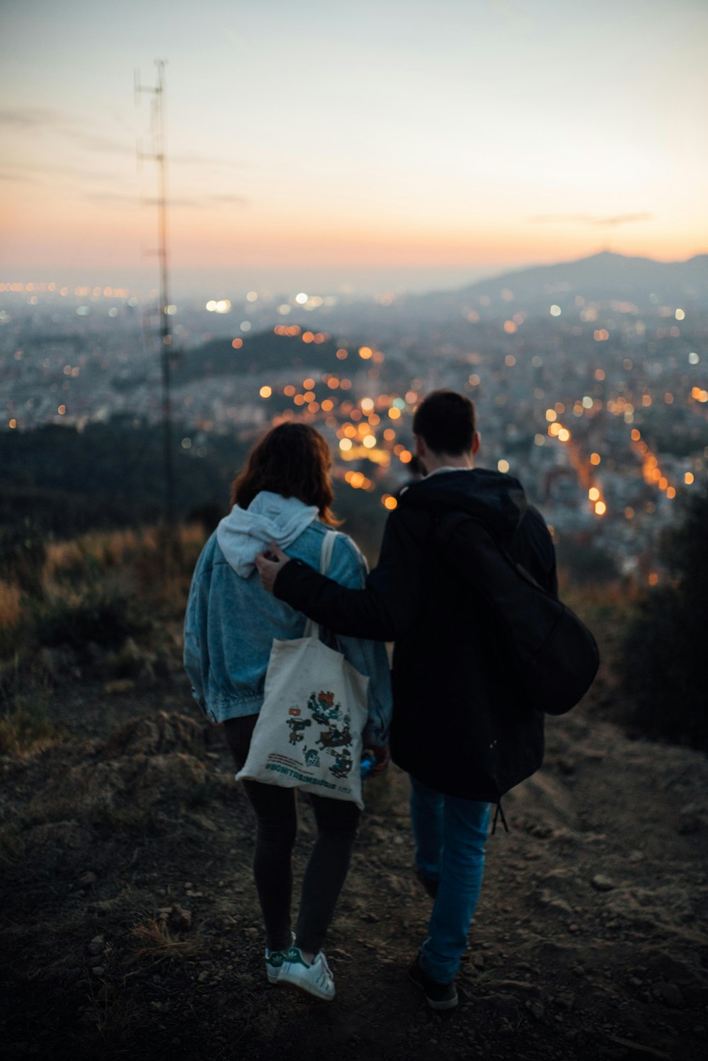 person putting left shoulder on another person while walking on pathway