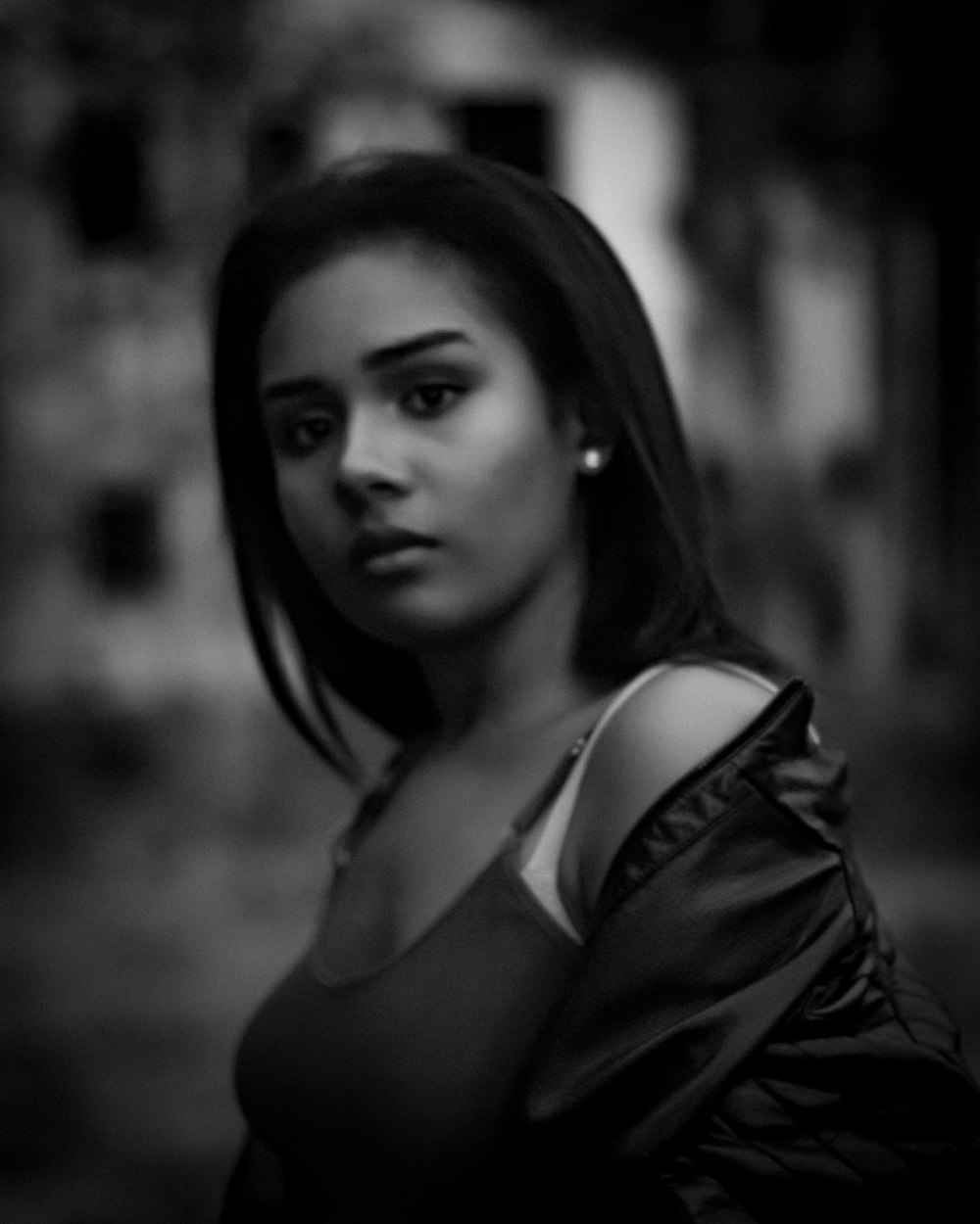 woman in tank top and jacket grayscale photo