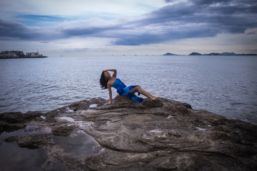 woman sitting on rock fragment