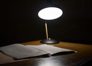 black table lamp beside book