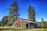 A freshly built rustic pole barn standing proudly under a clear blue sky in rural Pennsylvania.