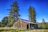 A freshly built rustic pole barn standing proudly under a clear blue sky in rural Pennsylvania.
