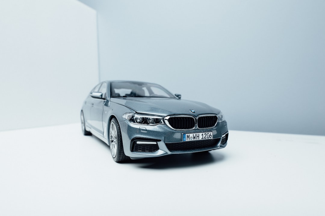 grey BMW vehicle near white wall