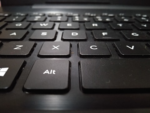 A close-up view of a black keyboard with white letters, focusing on the keys with letters A, S, D, F, Z, X, C, V, and the Alt key.