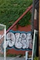 a wall with graffiti on it next to a fence