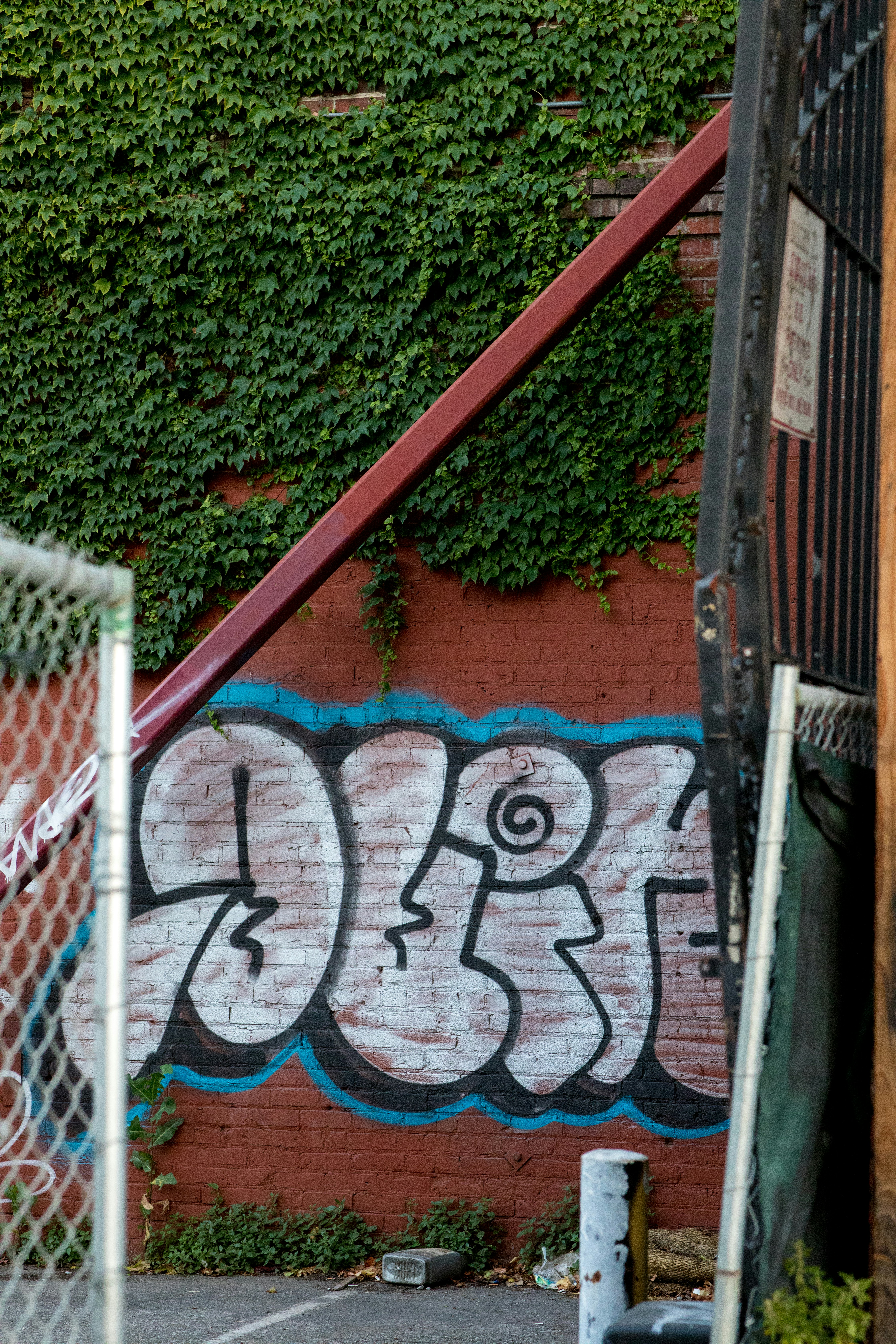 a wall with graffiti on it next to a fence