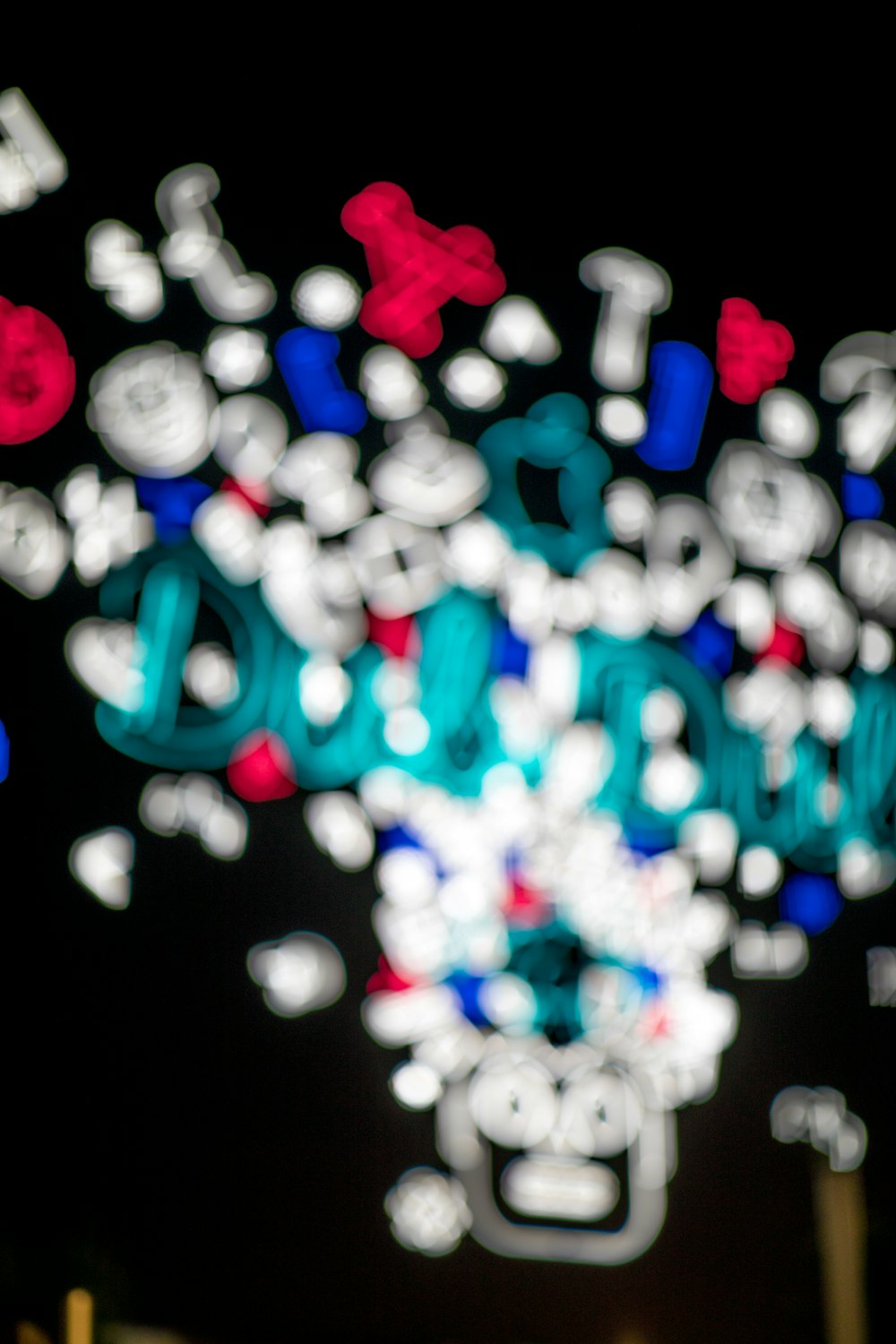 a close up of a street sign with lights in the background