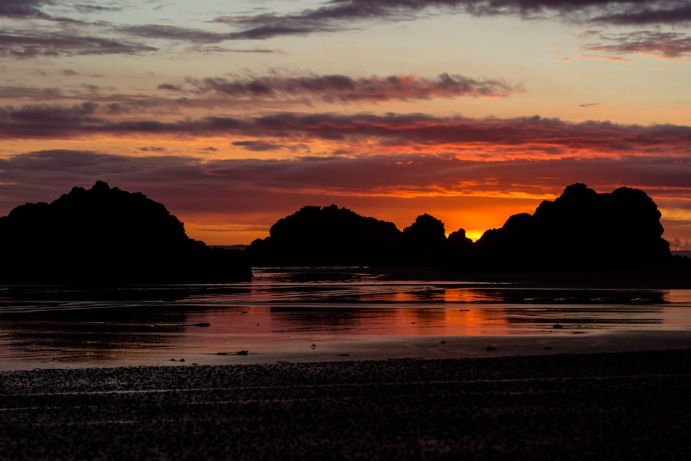 sunset on rock formation at the shore