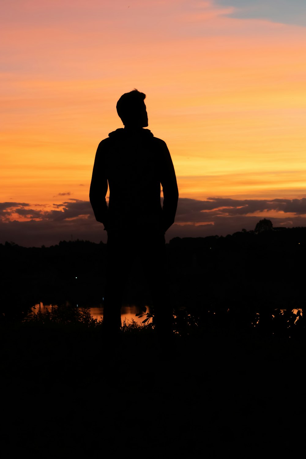 silhouette of man under yellow sky